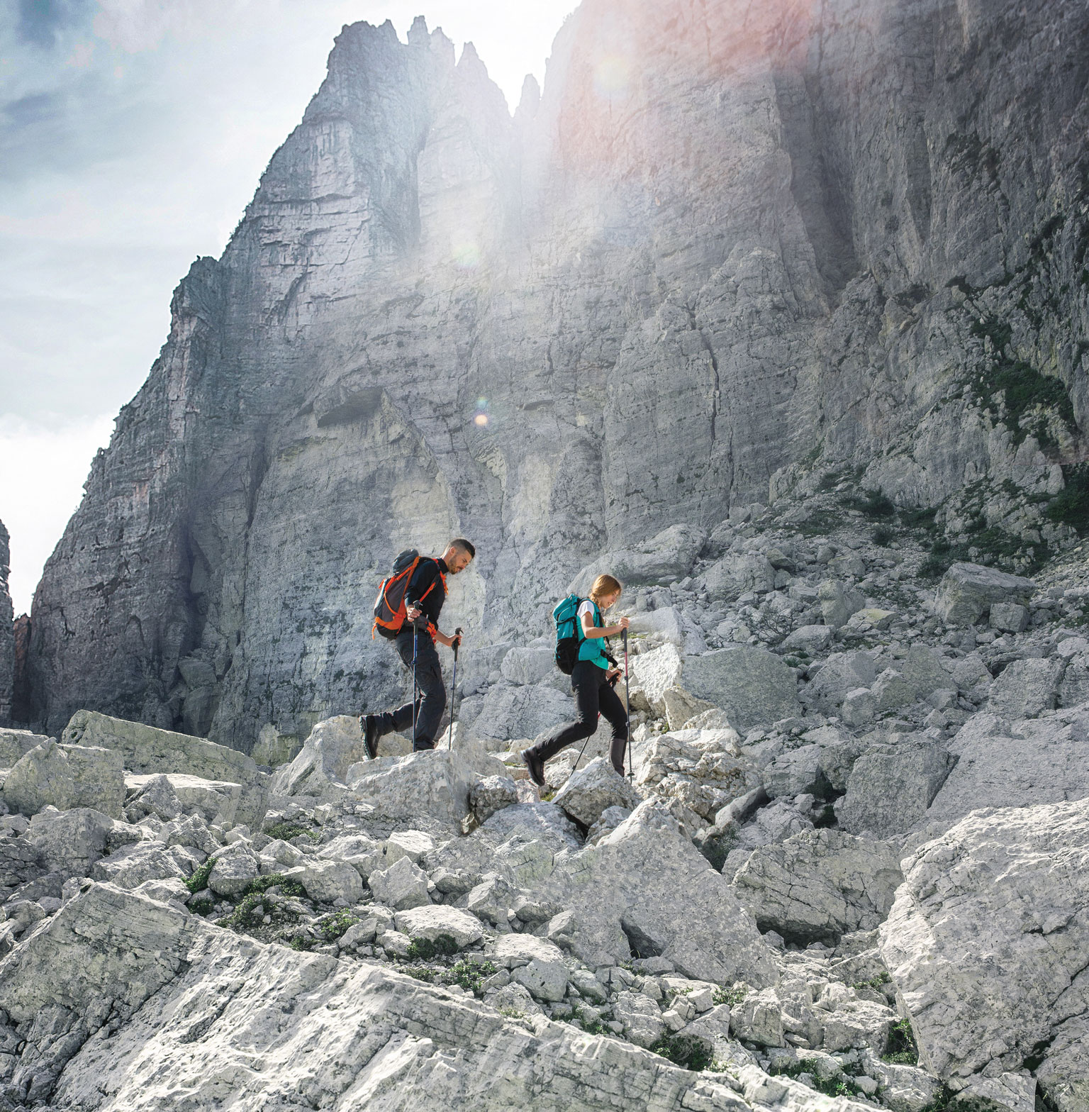 Two Backpackers Walking in the Dolomite Mountains