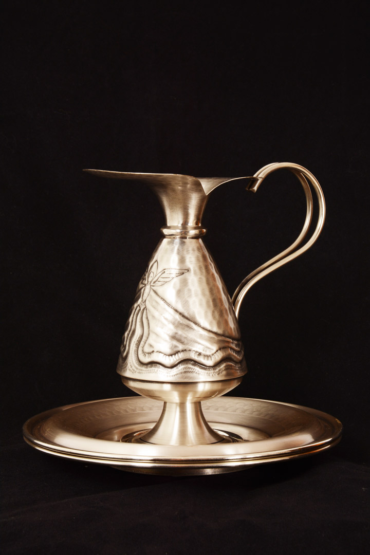 Brocca con due piatti in metallo cesellato