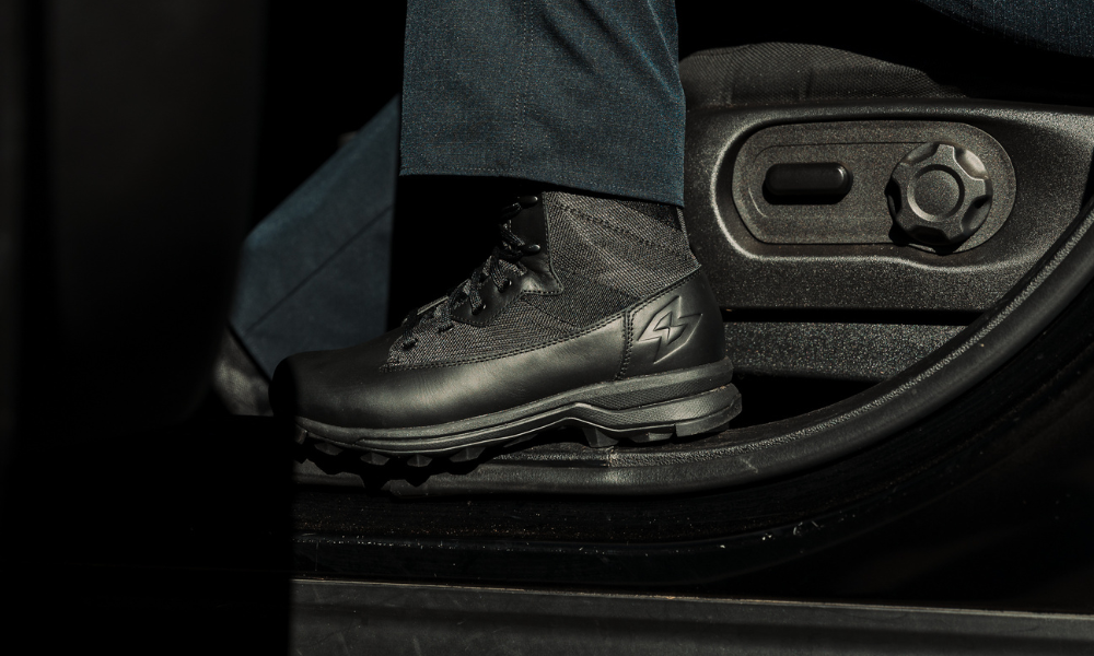 Close-up of Garmont tactical boot, worn inside a police car, next to seat controls