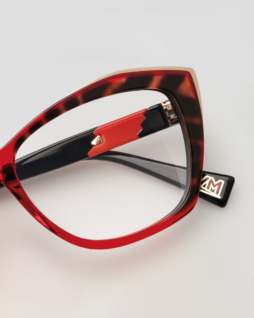 Elegant woman with glasses La Matta  and a scarf, exuding sophistication and style.