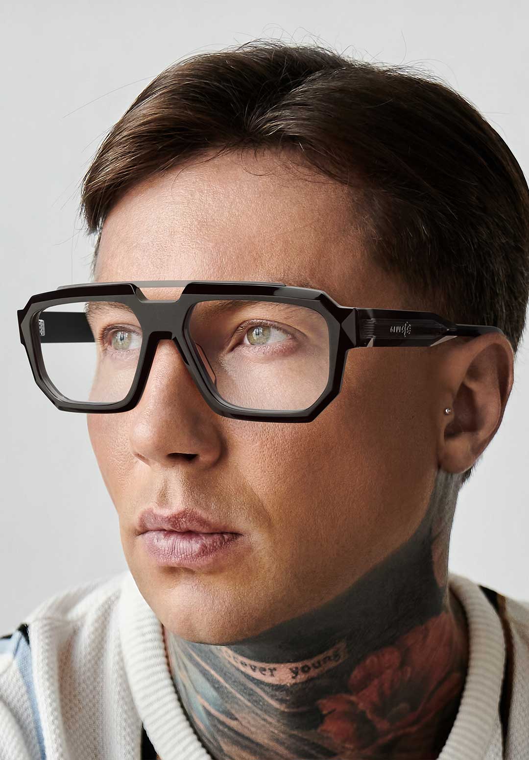 A sophisticated man sitting elegantly on top of a pair of stylish Genesis glasses.