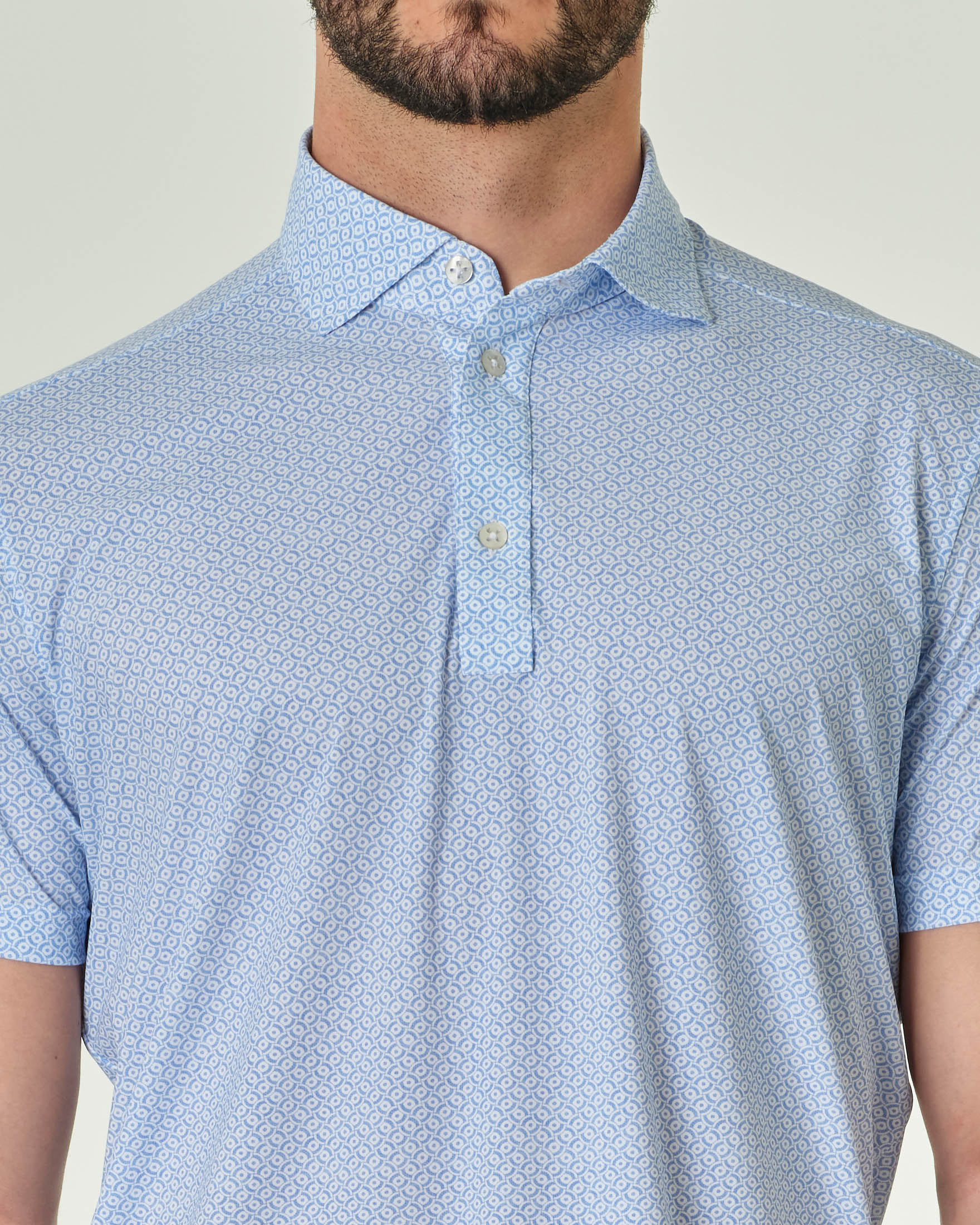 Polo micro fantasia bianca e azzurra in tessuto tecnico hyper comfort