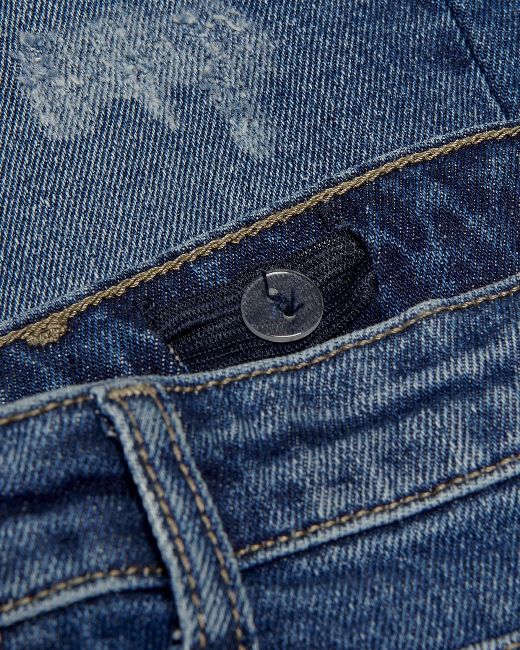Jeans blu scuro stone washed con abrasioni 10-14 anni