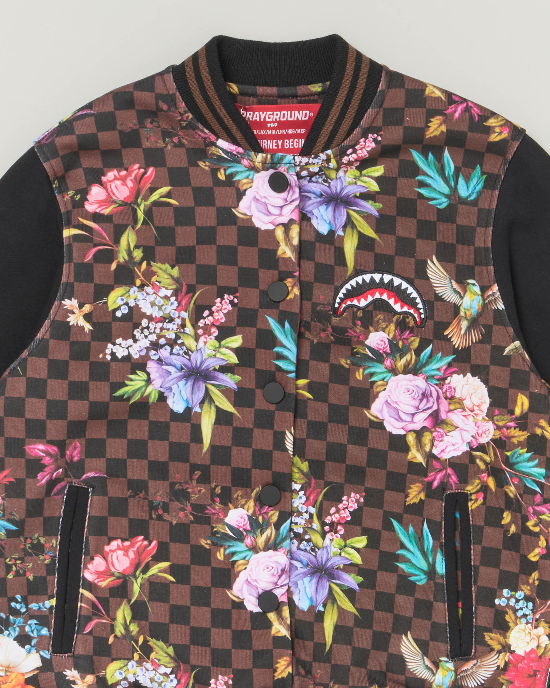 Bomber in fantasia check marrone e nera con grafica floreale e maniche nere 10-16 anni image