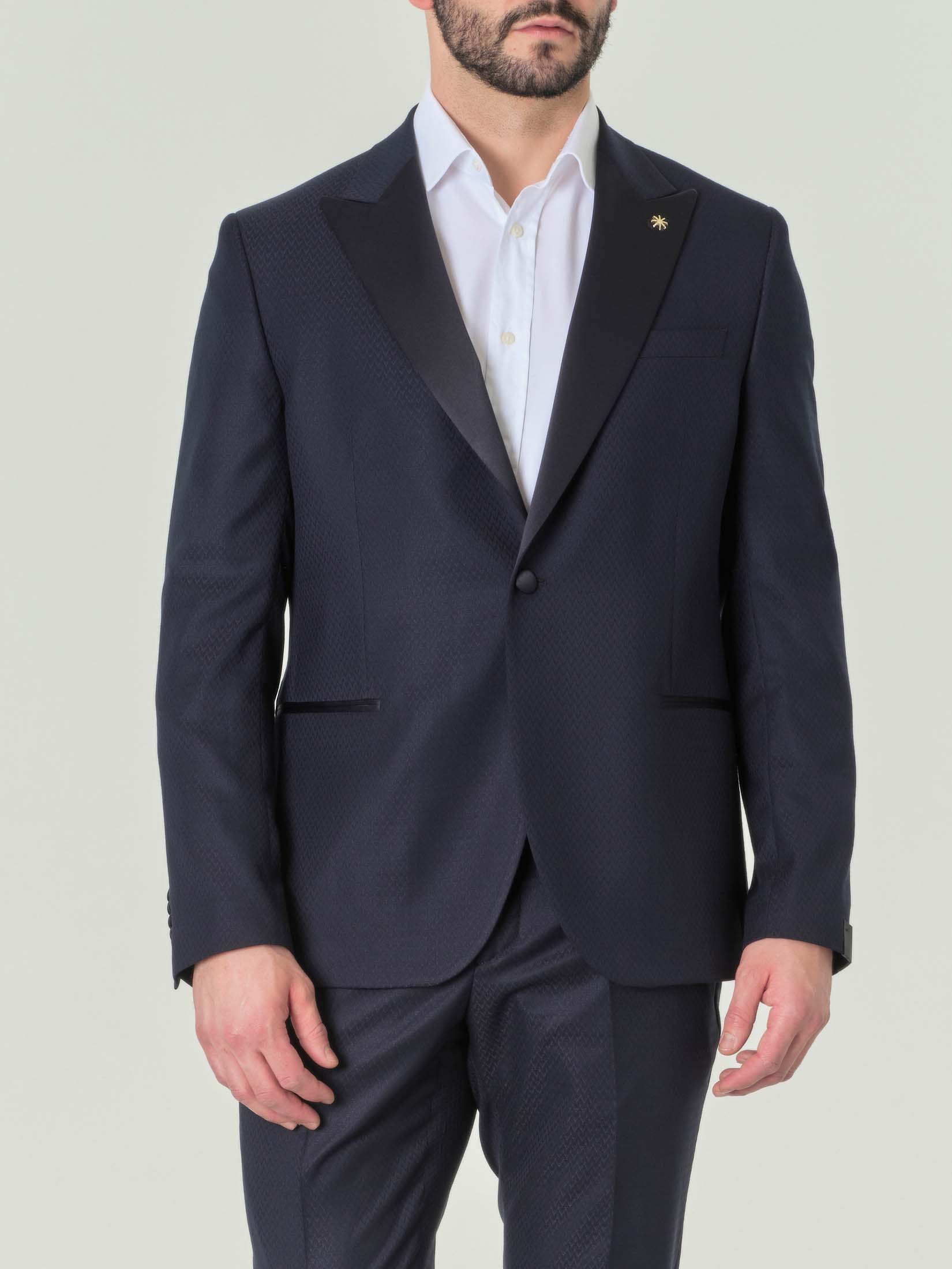 Abito blu in tela stretch fantasia microspinata con revers a lancia image