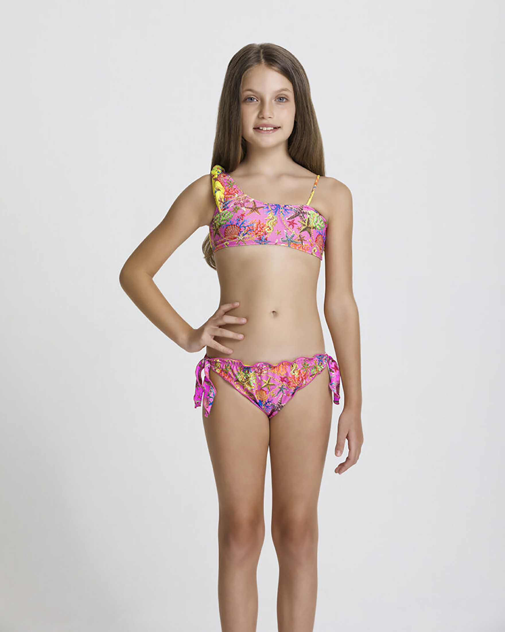 Bikini monospalla fucsia reversibile in giallo con fantasia stelle marine e profili ondulati