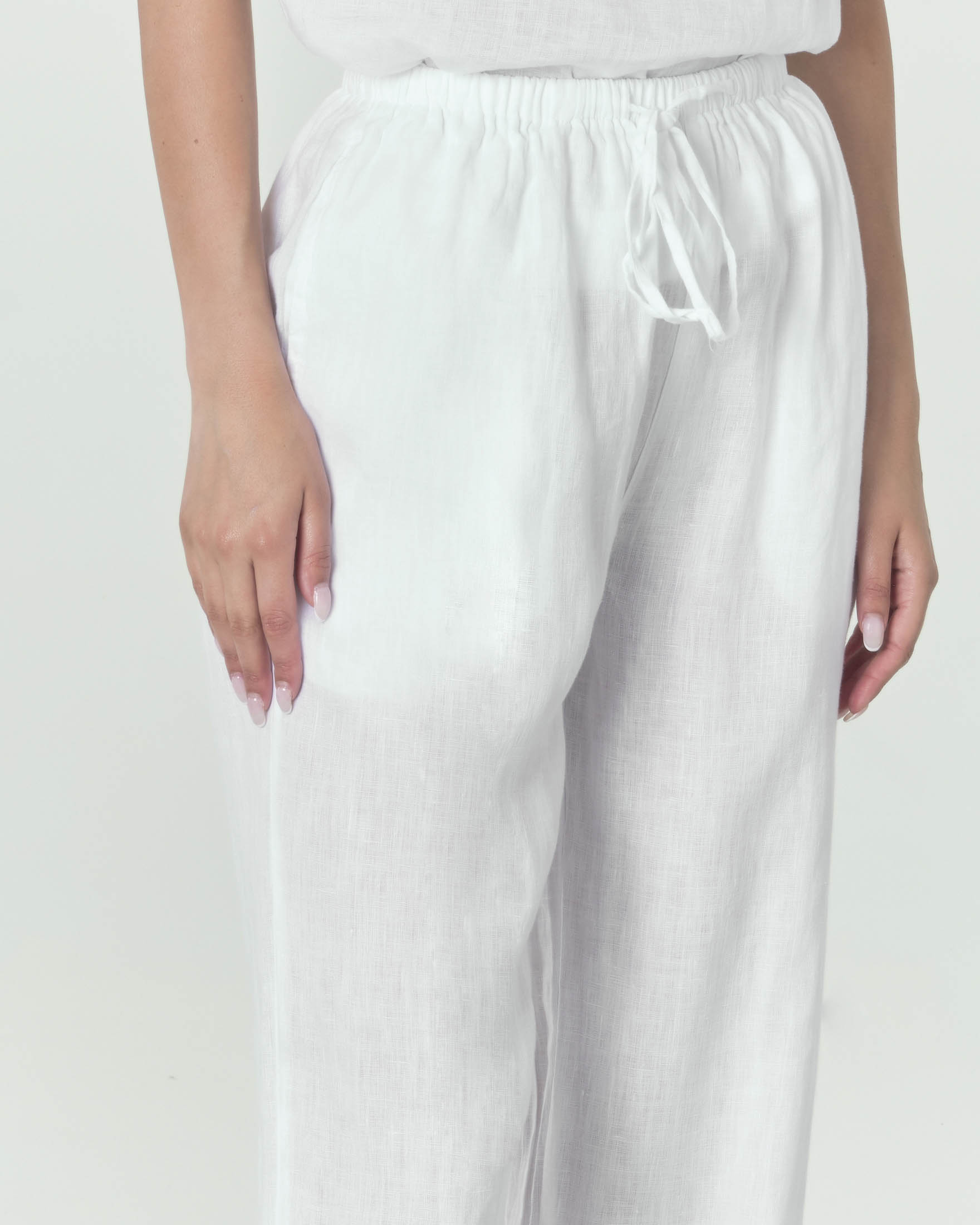 Pantaloni palazzo bianchi in lino con fascia in vita con elastico inserito image