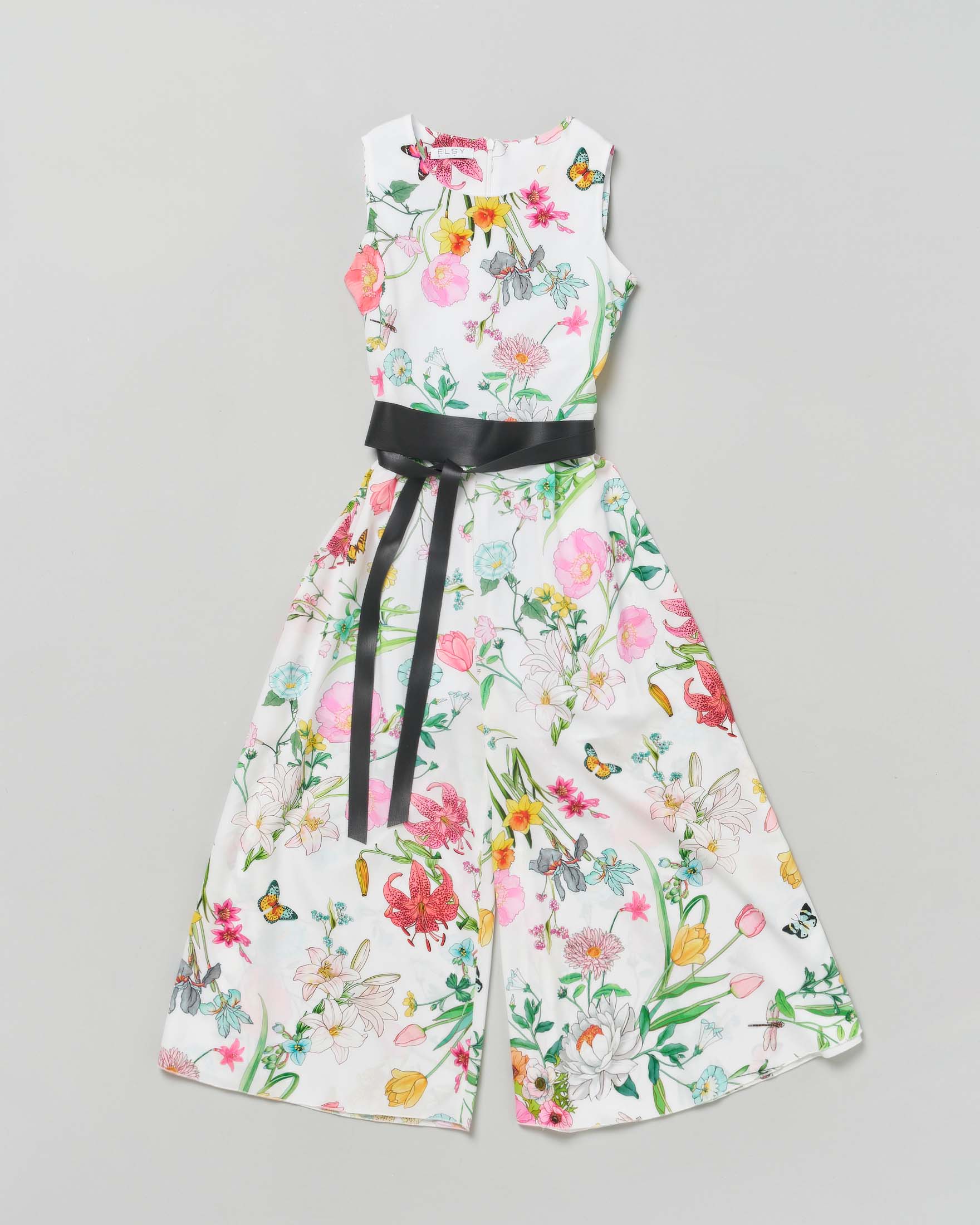 Tuta bianca smanicata in fantasia floreale con pantalone a palazzo e fusciacca in ecopelle nera 