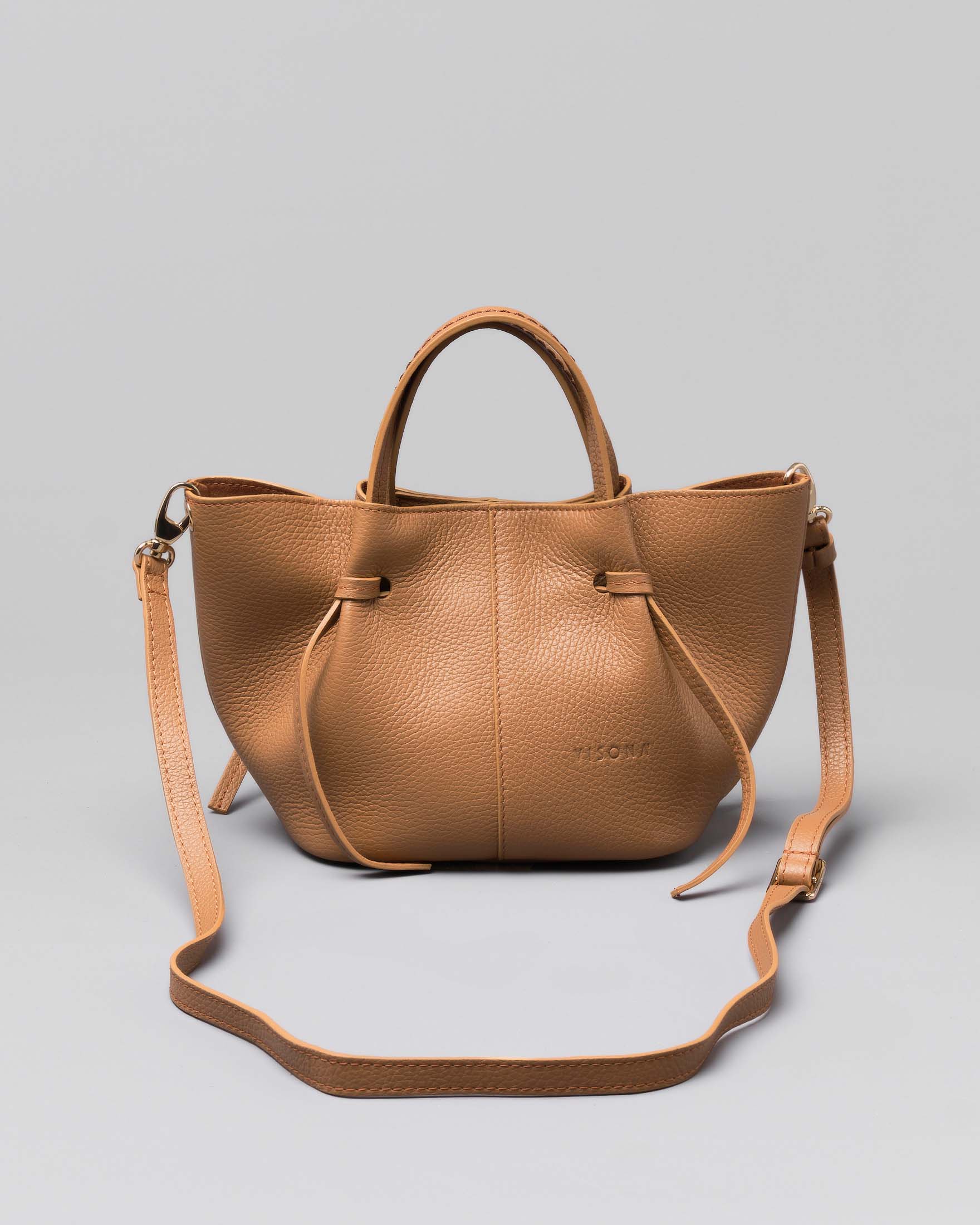 Borsa a mano rosa polvere a trapezio piccola in pelle bottalata