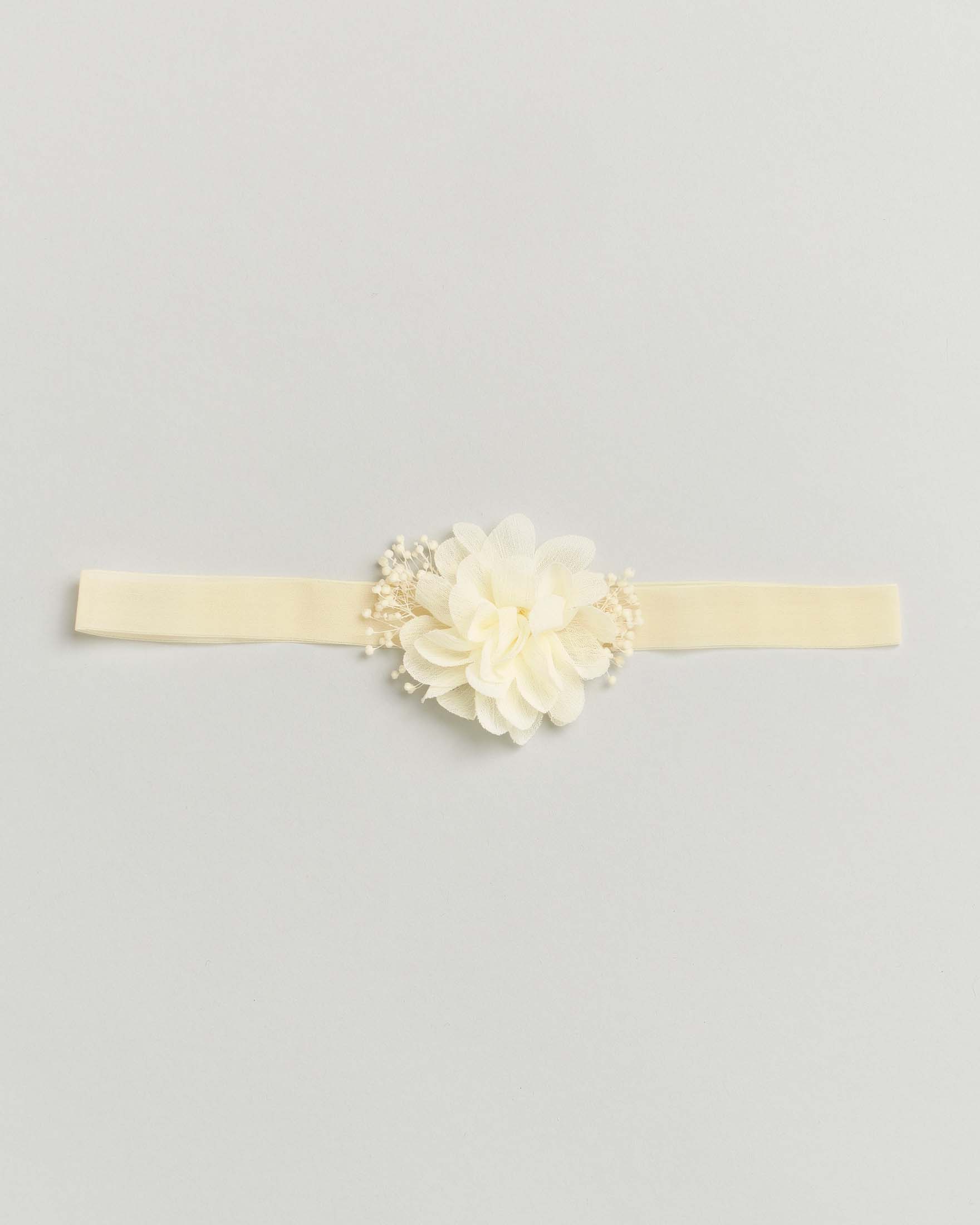 Fascetta color panna con fiore e decorazioni