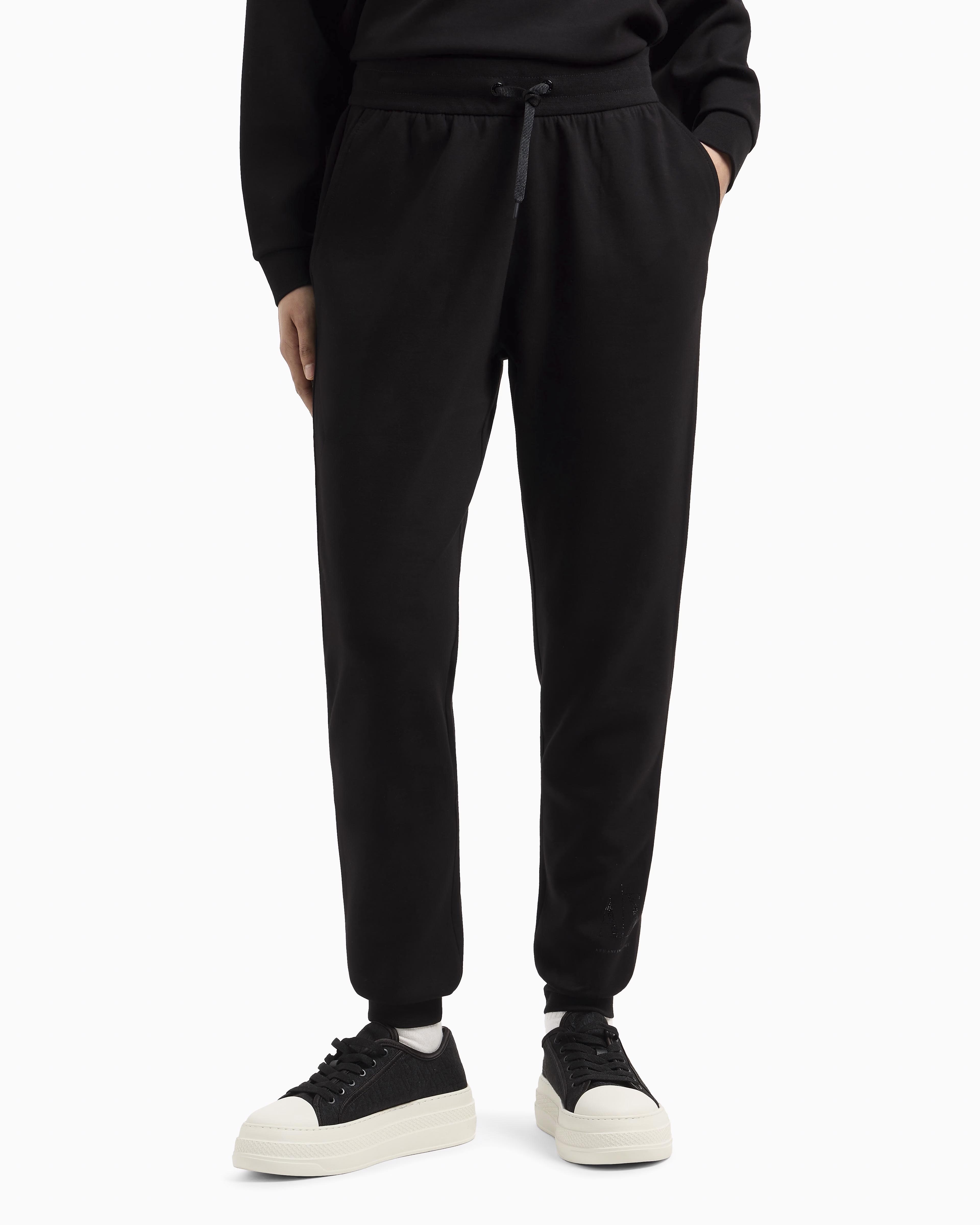 Joggers slim-fit neri Exchange in tessuto scuba con logo al fondo in strass applicati