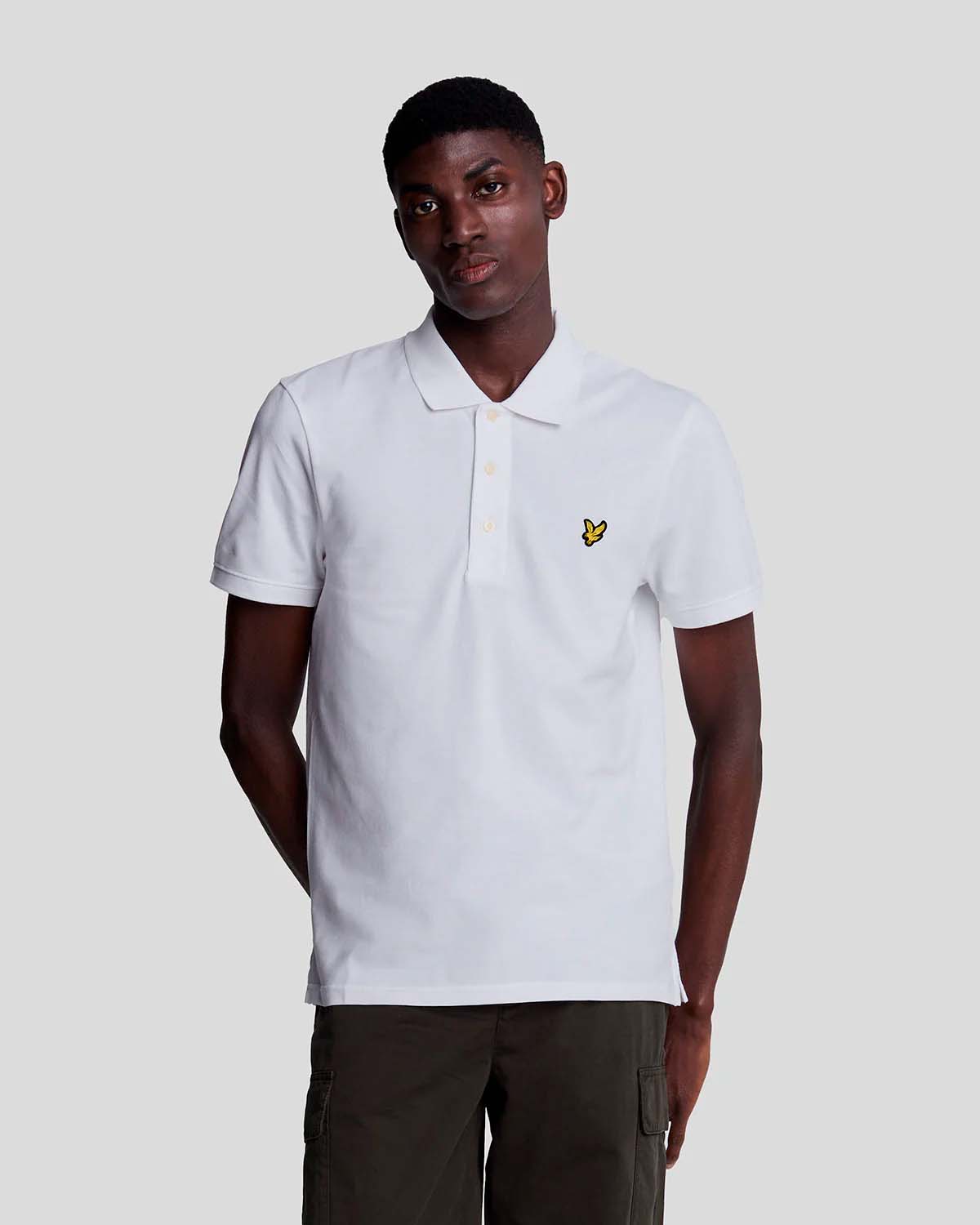 Polo bianca mezza manica in piqué di cotone stretch con logo aquila gialla ricamato sul petto