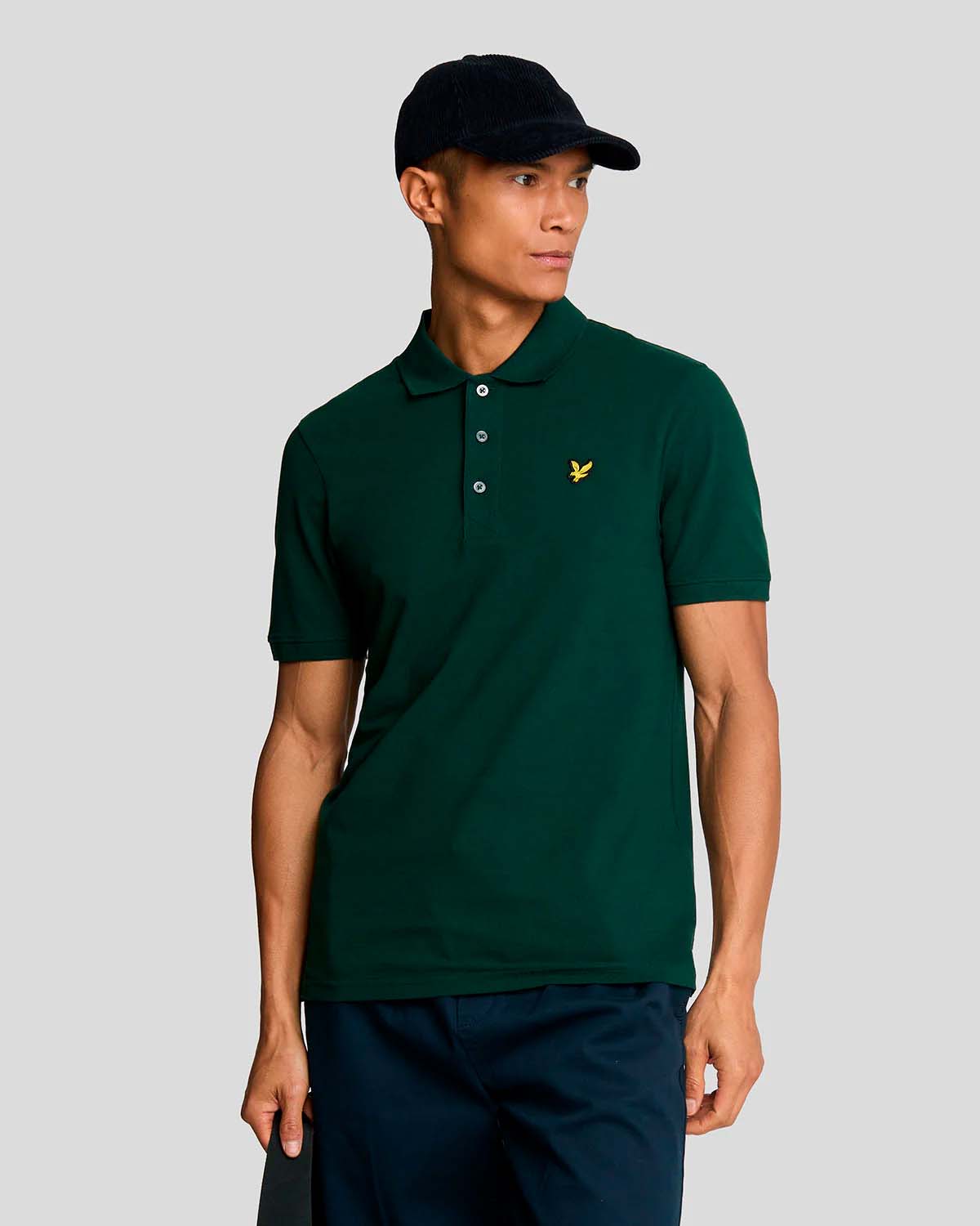 Polo verde scuro mezza manica in piqué di cotone stretch con logo aquila gialla ricamato sul petto