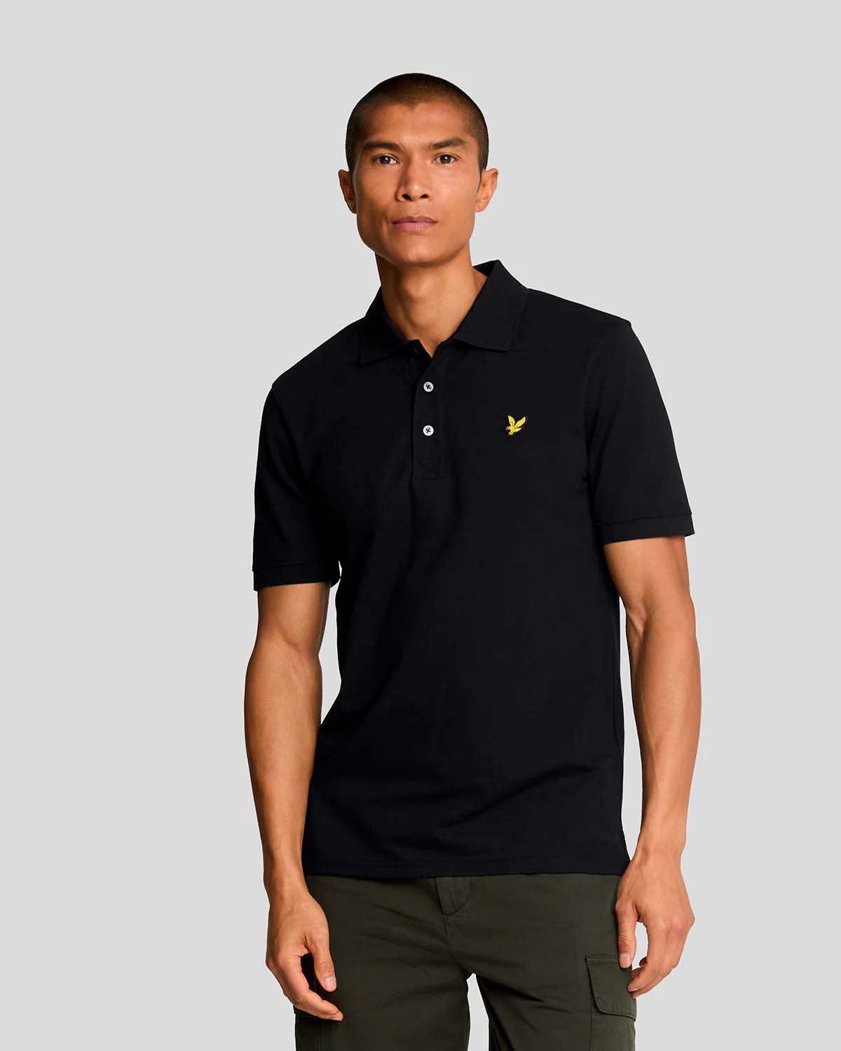Polo nera mezza manica in piqué di cotone stretch con logo aquila gialla ricamato sul petto