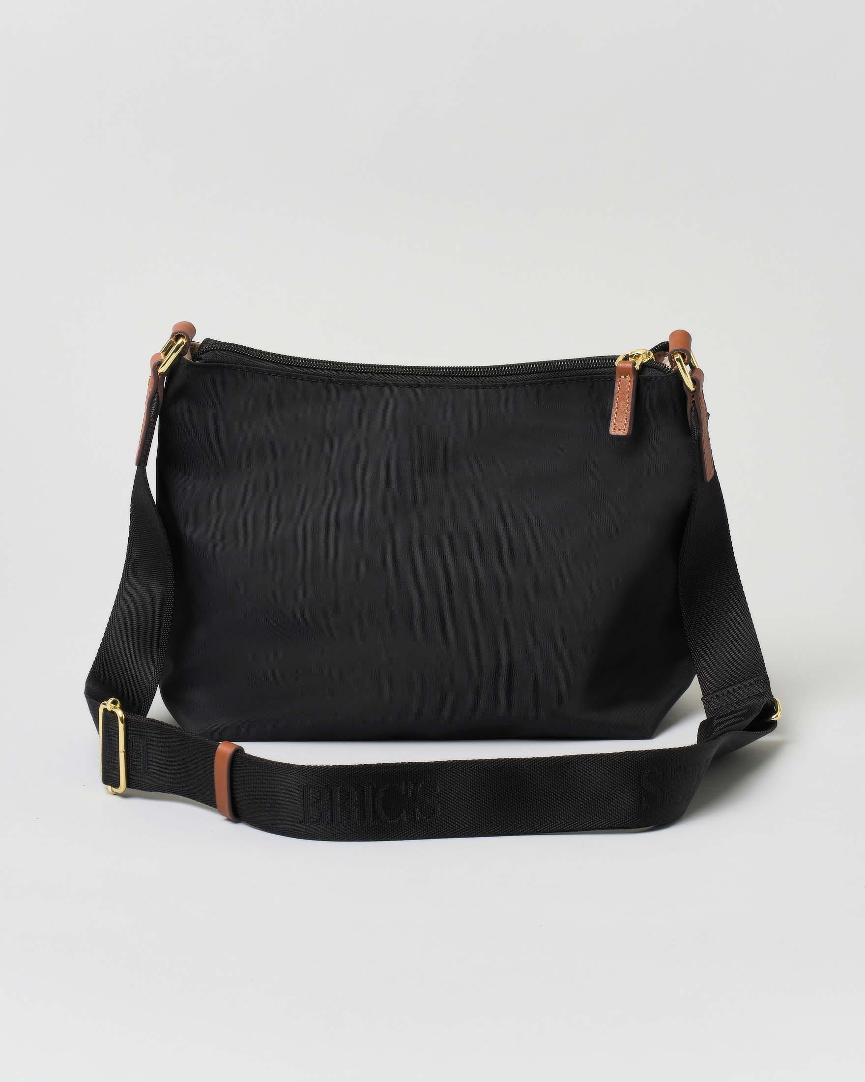 Borsa a tracolla nera Bric's in nylon con tracolla in tessuto regolabile e dettagli in pelle color cuoio