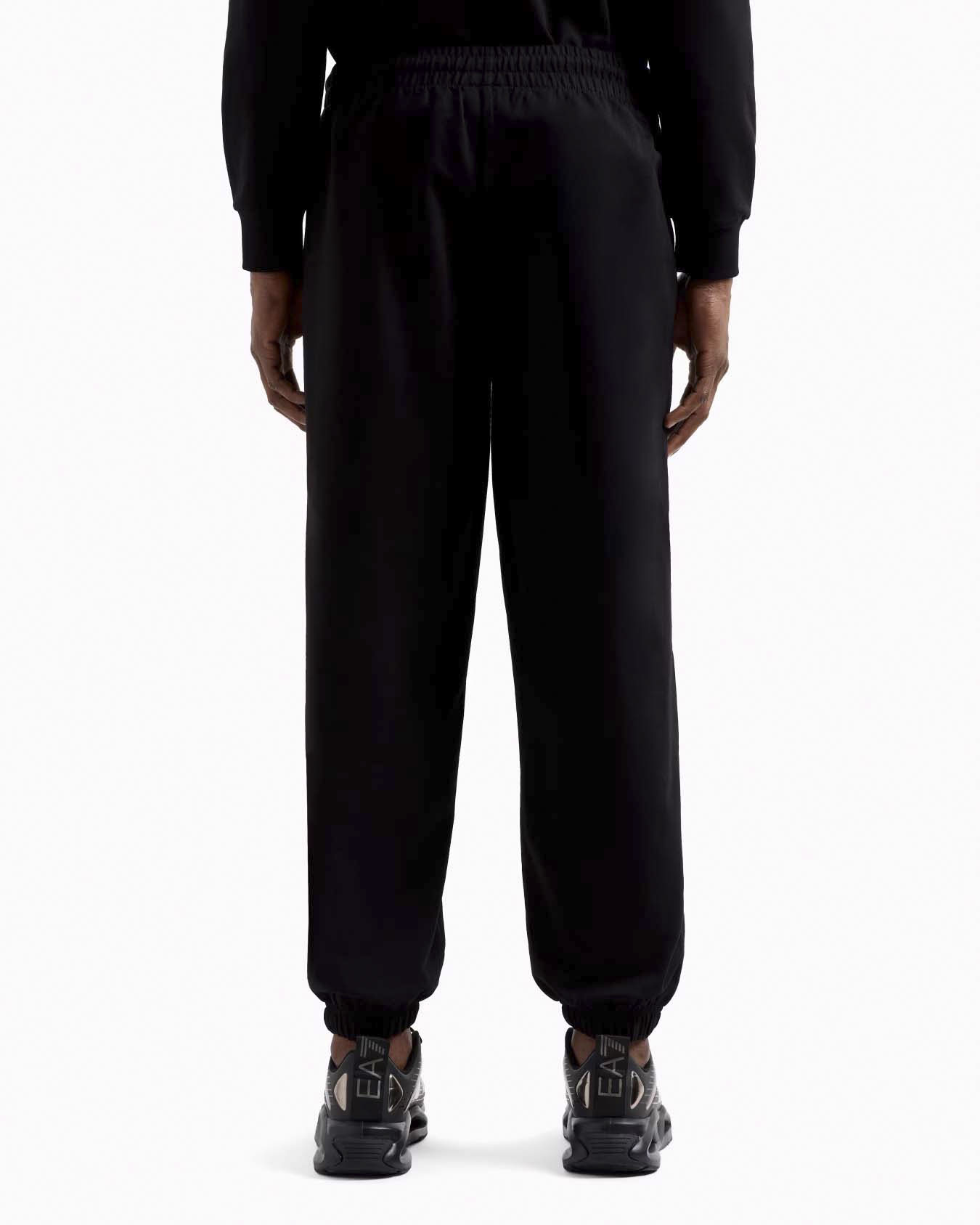 Pantalone EA7 nero in felpa con maxi logo gommato in tono sulla gamba sinistra image