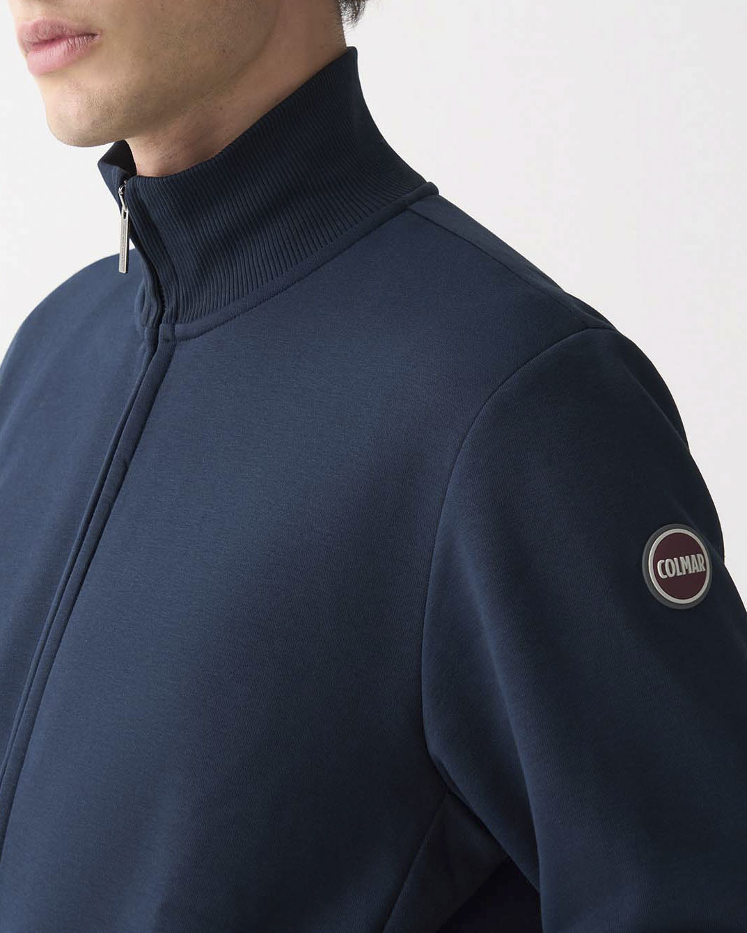 Felpa Colmar Originals blu con chiusura zip e logo bollo applicato sulla manica