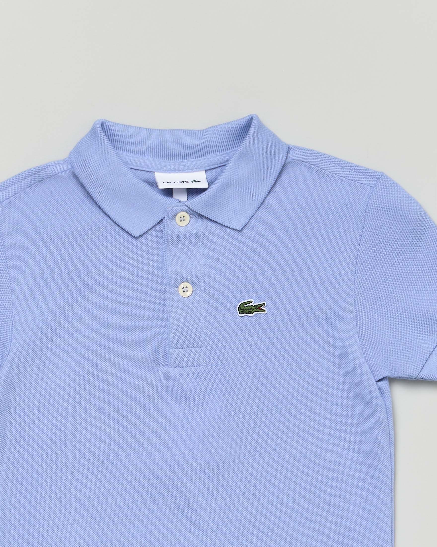 Polo Lacoste celeste piqué di puro cotone image