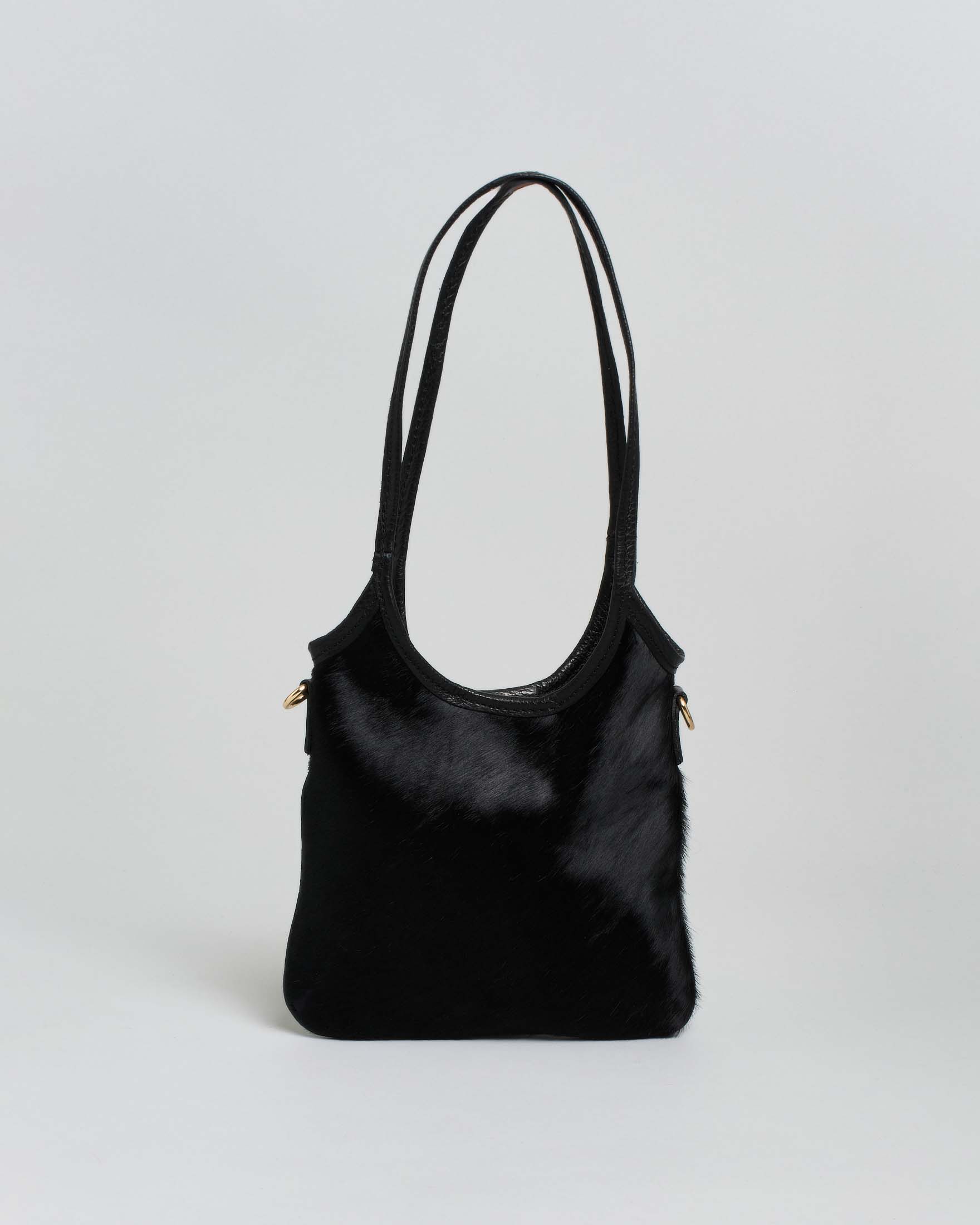 Mini tote bag nera in pelle martellata con parte frontale in cavallino tono su tono