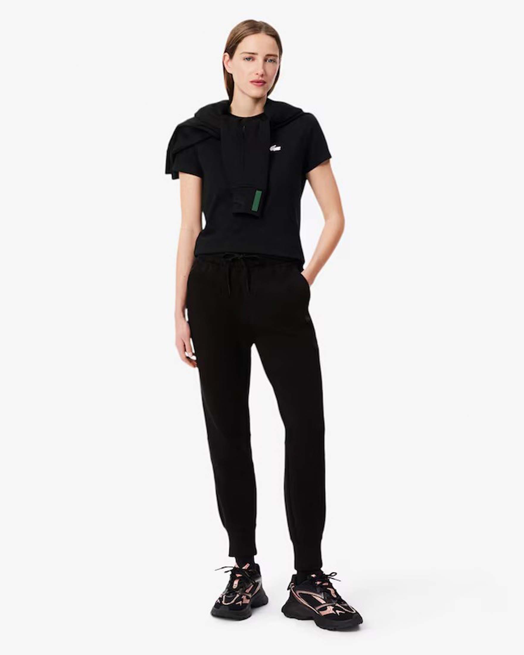 Pantaloni neri tapered Lacoste in misto cotone effetto neoprene con polsini al fondo