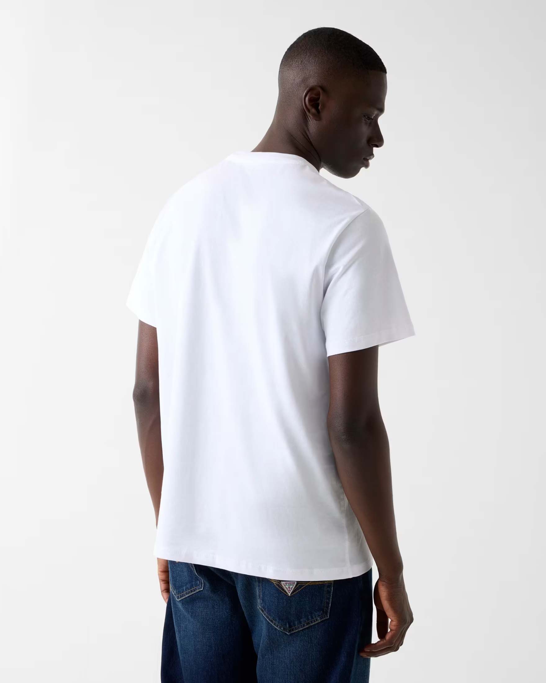 T-shirt Guess bianca in cotone con logo triangolo ricamato image