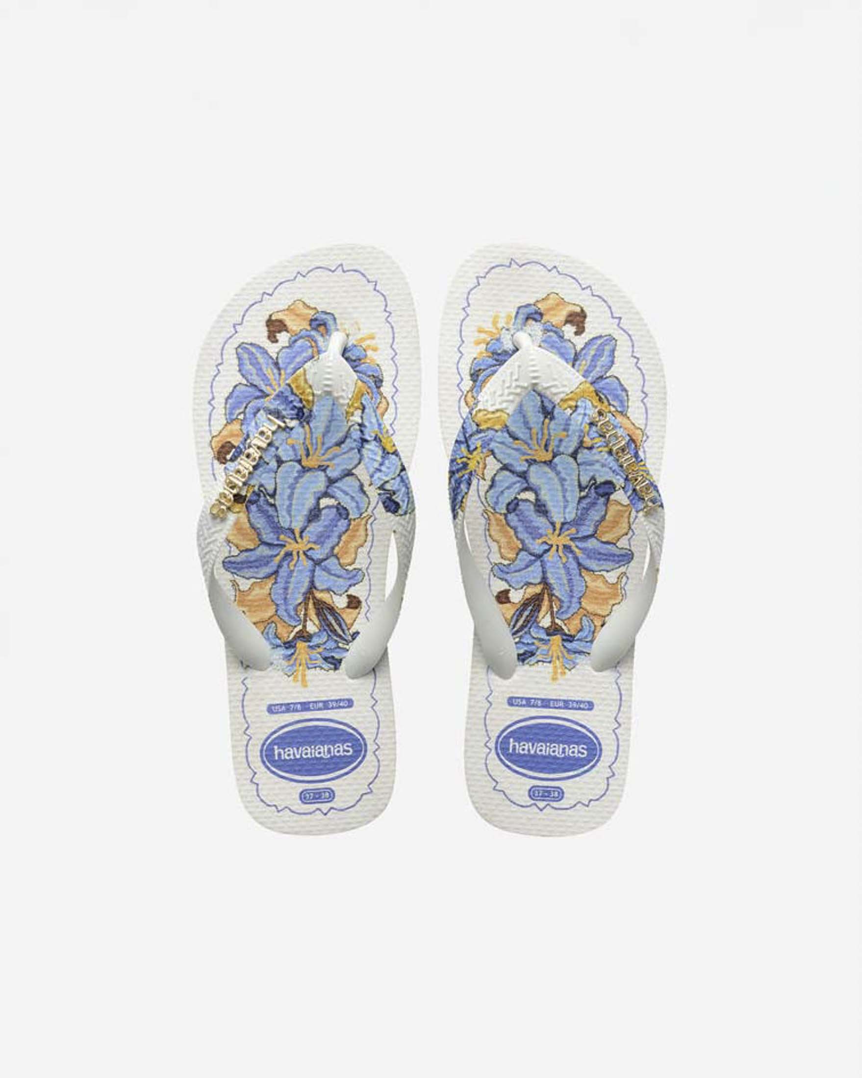 Ciabatte infradito Top Tropicalia Vibes II Havaianas bianche con stampa a fiori azzurra e logo dorato image