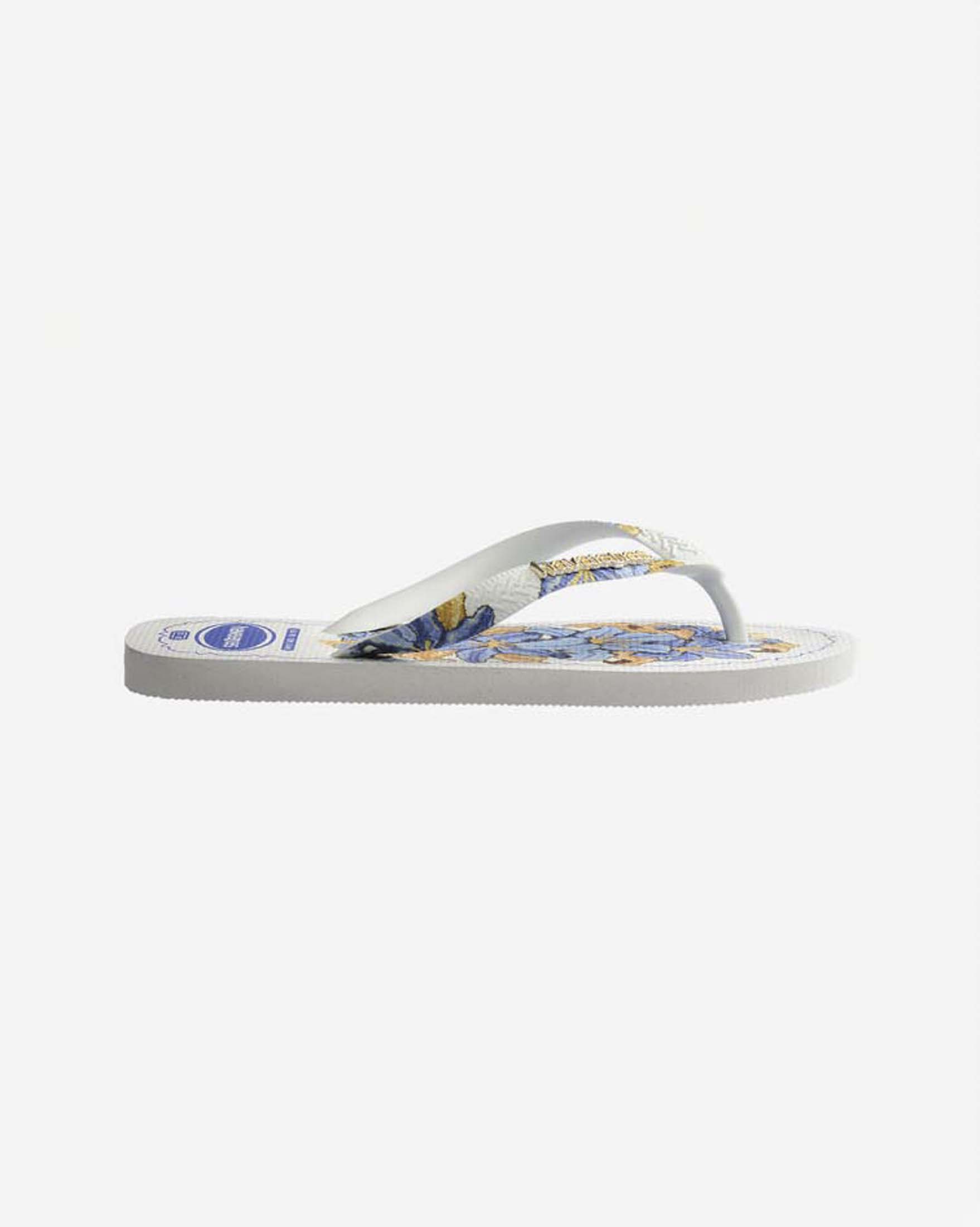 Ciabatte infradito Top Tropicalia Vibes II Havaianas bianche con stampa a fiori azzurra e logo dorato