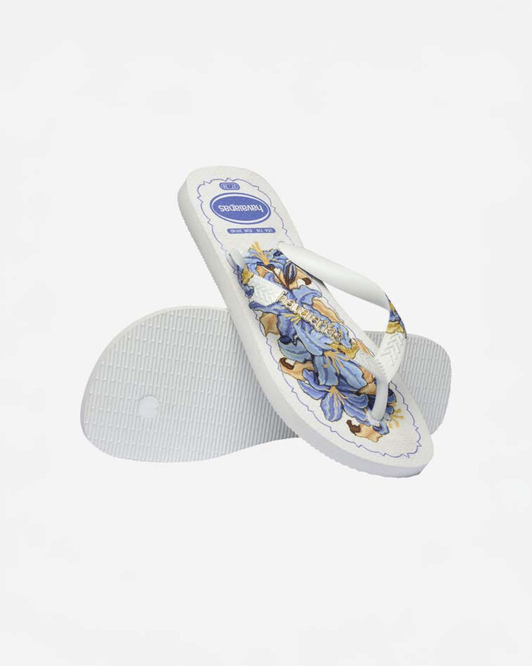 Ciabatte infradito Top Tropicalia Vibes II Havaianas bianche con stampa a fiori azzurra e logo dorato