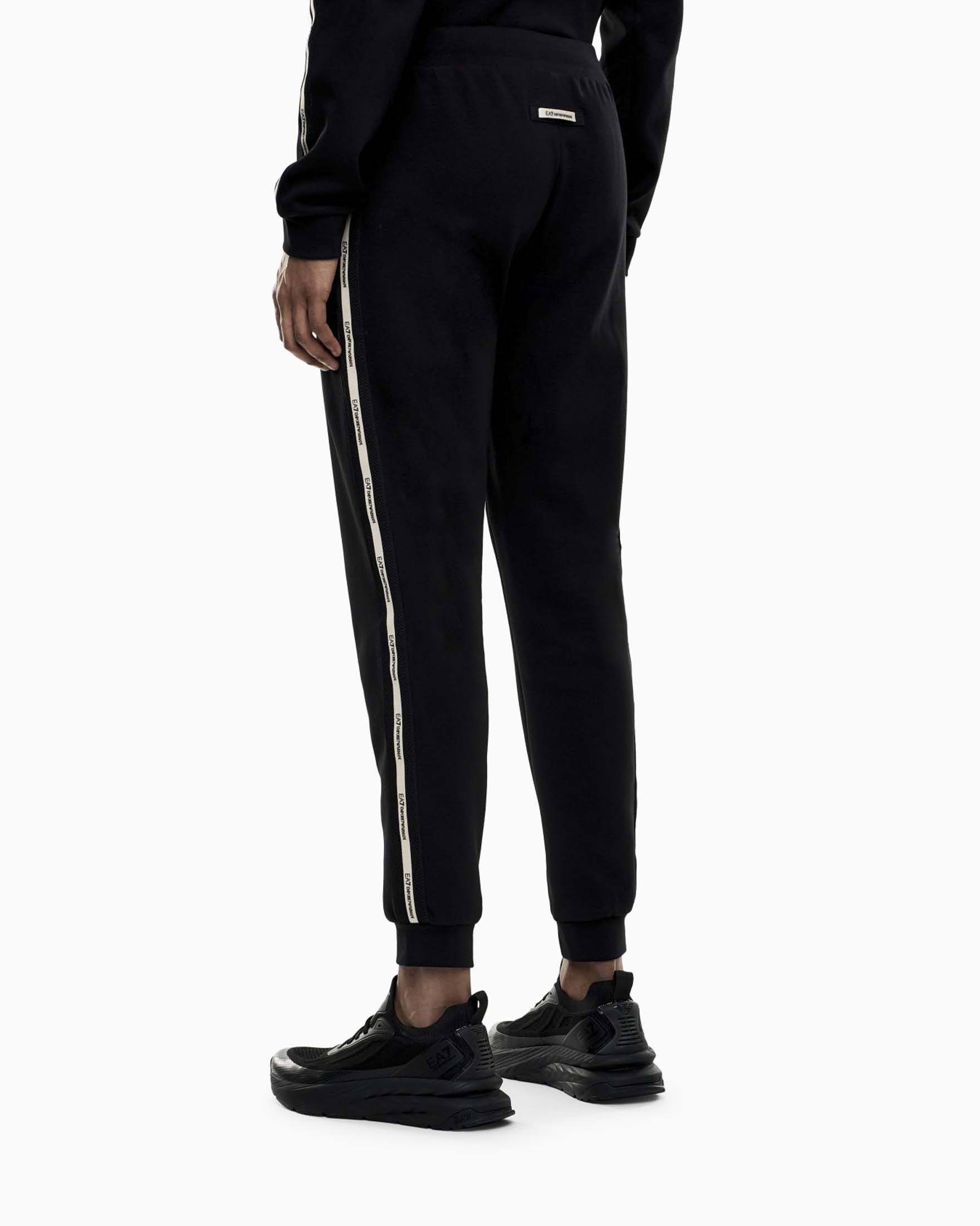 Pantaloni jogger EA7 neri in misto cotone con banda laterale logata image