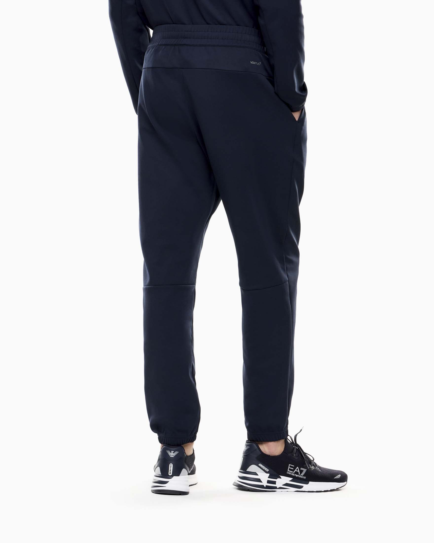 Pantaloni jogger EA7 blu in tessuto tecnico con patch logo image