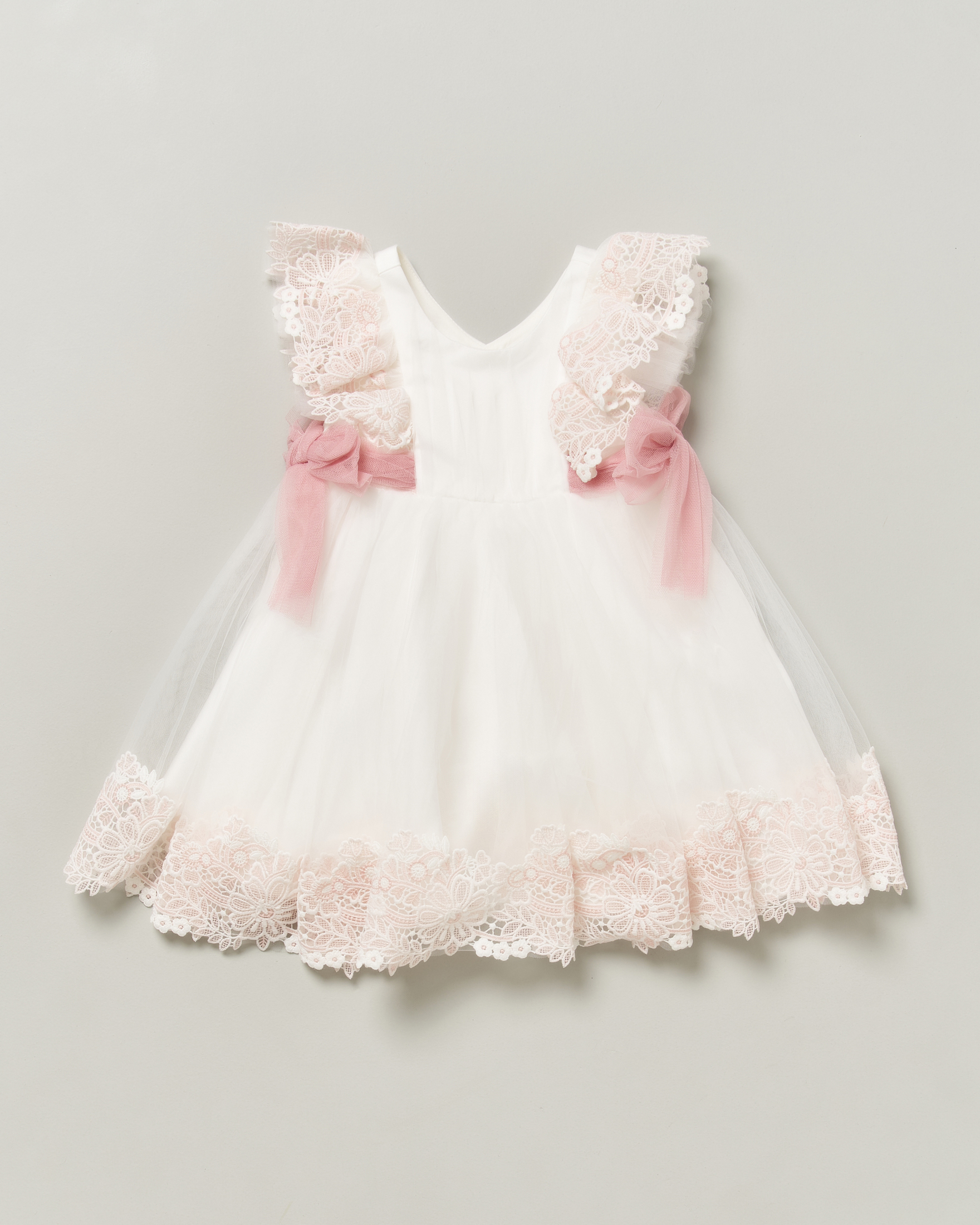 Abito bianco Abel & Lula in tulle e pizzo con dettagli rosa e fiocchi