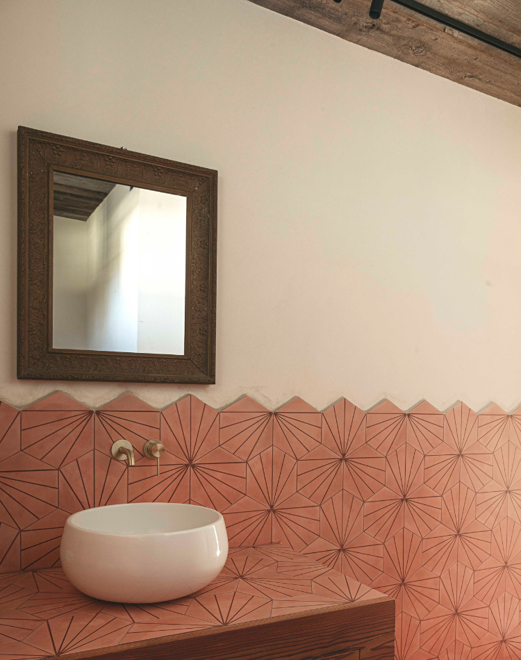 bagno con soffitti in legno e rivestimenti in piastrelle decorate
