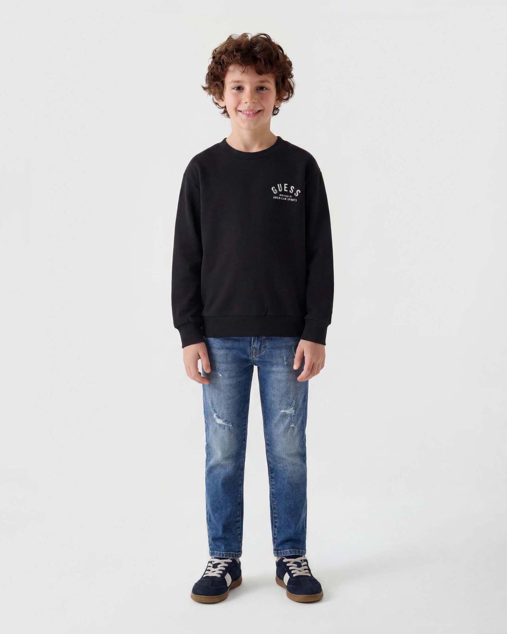 Jeans slim fit Guess dal lavaggio medio in misto cotone con rotture