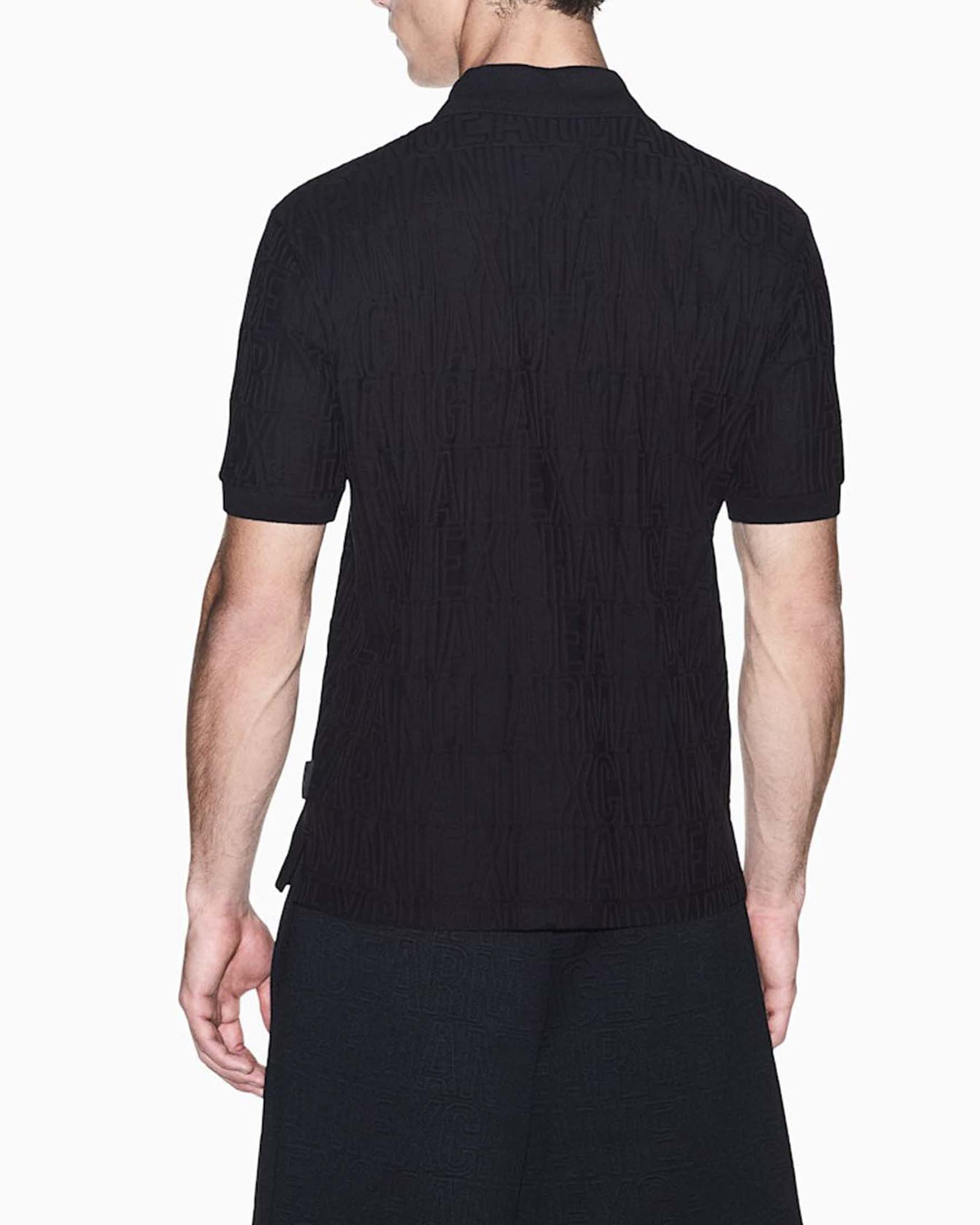Polo Armani Exchange nera in cotone con motivo logo in rilievo image
