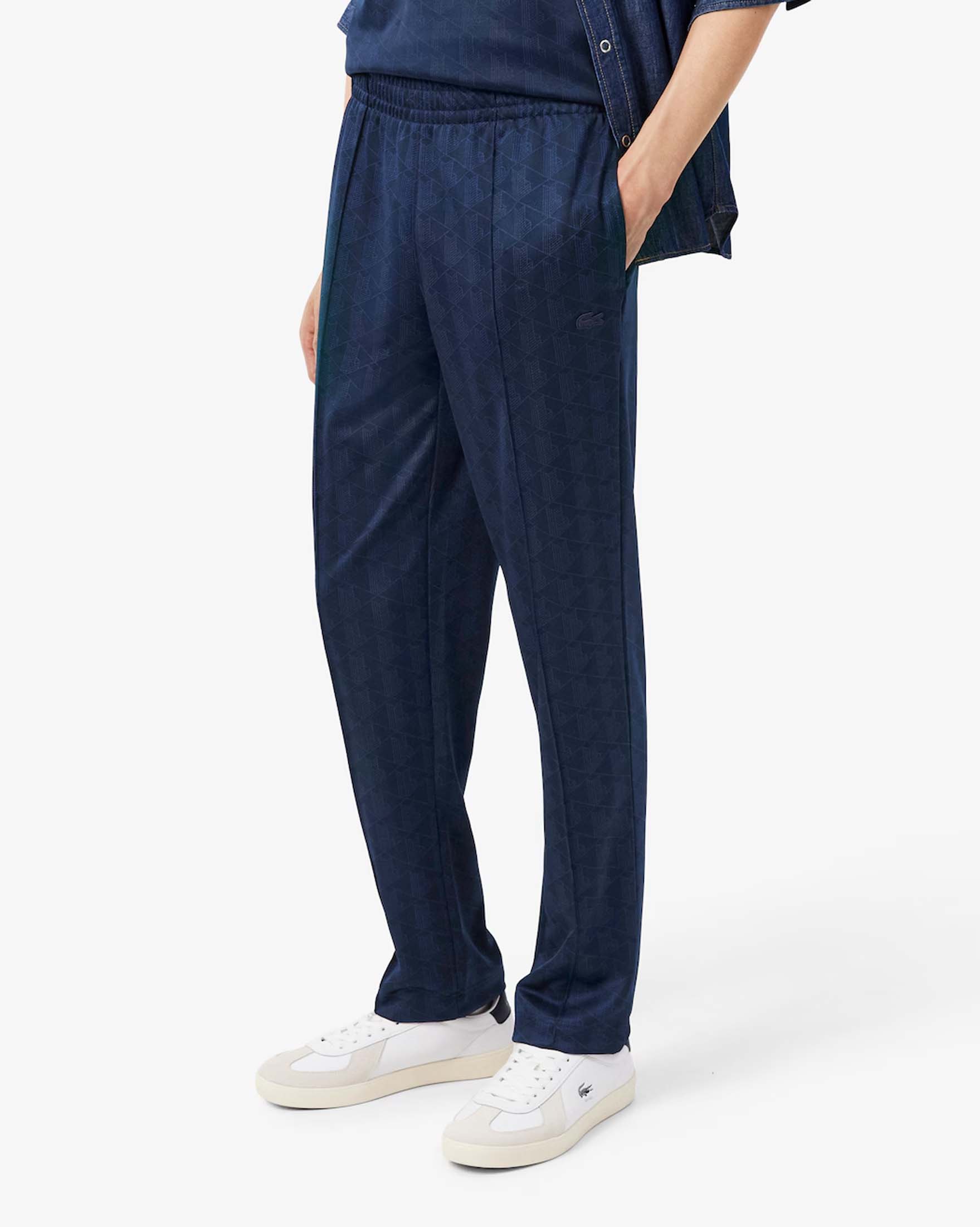 Pantaloni jogger Lacoste blu navy in tessuto jacquard stretch con monogramma image